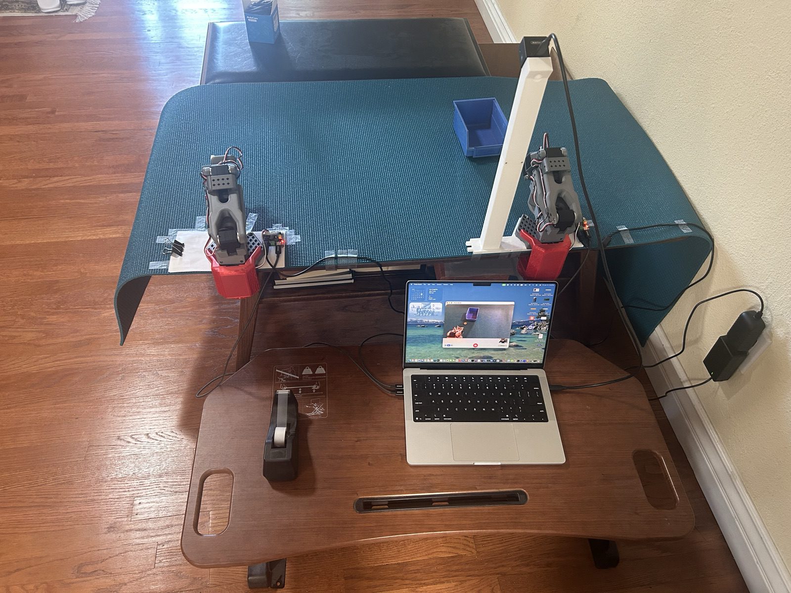 The arm rig with the overhead camera and a laptop showing the camera feed